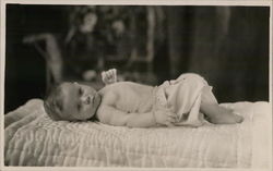 A Baby Laying on a Blanket Postcard