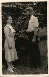 Man and Woman Outdoors Near Pine Tree Postcard