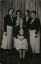 Four Women Standing Around One Woman in a Chair Postcard