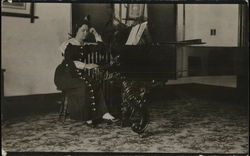 A Woman Sitting at a Piano Postcard