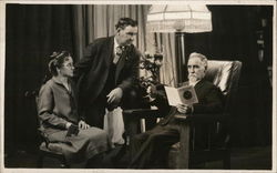 Three People Sitting in a Living Room Postcard