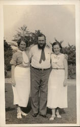 Man Standing Between Two Women Postcard