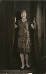 A Woman Posing Between Curtains Postcard