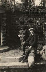 Man Seated on Rocks Near Pennant: "1922 Eden Springs" Postcard