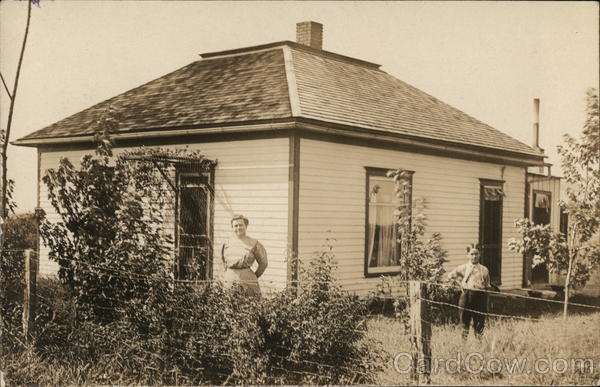 Woman and Boy Standing in Yard Near House Children