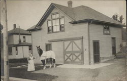 Woman Standing Outside, Holding Horse's Reigns Near Barn Door Woman Standing Outside, Holding Horse's Reigns Near Barn Door