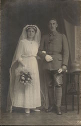 Bride in White Dress with Bouquet and Soldier in Uniform Bride in White Dress with Bouquet and Soldier in Uniform