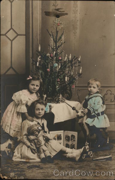 Young Children in front of Christmas Tree
