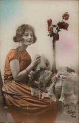 Woman Sitting Next to Flowers Postcard
