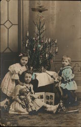 Young Children in front of Christmas Tree Postcard
