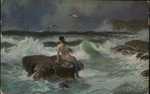 Mermaid on a Rock Surrounded by High Waves and Looking Out Into the Ocean