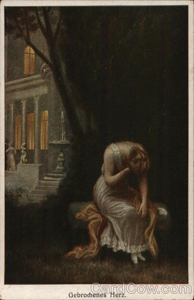 Blond Woman in Gown With Head Down Seated Outdoors