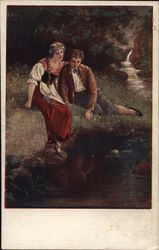 Young Man and Woman Seated Near Water's Edge in Grass Postcard