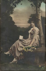 Woman Holding Floral Bouquet and Book Seated Near Tree Women Postcard Postcard
