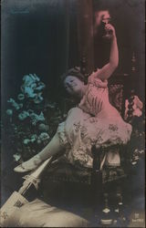 Smiling Woman Holding Stemmed Glass in Air Near Flowers Smiling Woman Holding Stemmed Glass in Air Near Flowers