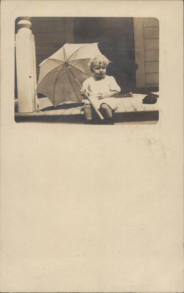 Baby Holding Umbrella on Porch Children