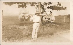 Man Carrying Hats Postcard