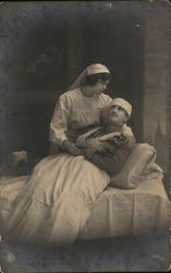 Uniformed Nurse Cradling Injured Soldier Uniformed Nurse Cradling Injured Soldier