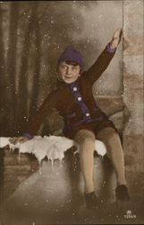 Boy sitting on a snowy ledge Boy sitting on a snowy ledge