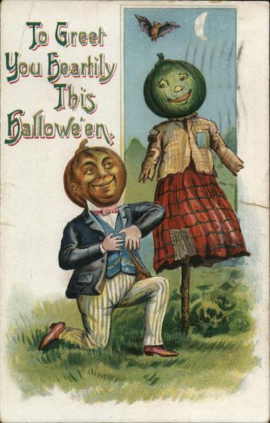 Man with Jack-o-Lantern head kneeling next to female scarecrow with a Jack-O-Lantern head