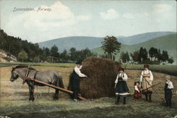 Farming family with bale of hay Postcard