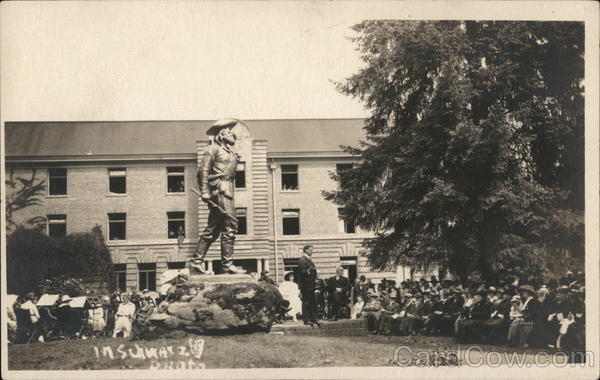 Lecture in front of large statue, college campus? Events