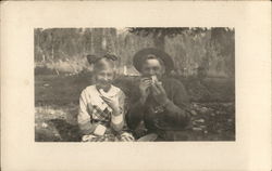 Snapshot of Couple at Picnic Eating Melons Postcard