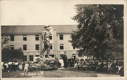 Lecture in front of large statue, college campus? Postcard