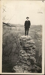 Man Standing on Tall Rick Pillar Men Postcard Postcard Postcard