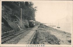 A railroad near a riverside. Postcard