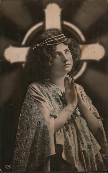 A woman praying in front of cross Religious