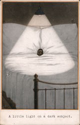 Black boy in bed underneath light: "A little light on a dark subject" Postcard