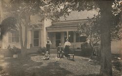 Family In Front of Home Postcard