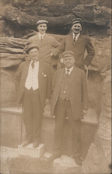 Four well-dressed men on a rock platform West Baden Springs Indiana