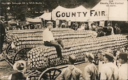 Our County Fair Contest on Corn - Man on Huge Ear of Corn Postcard