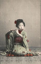 A Geisha lady with a flute Postcard