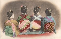 Four young ladies sitting facing backwards. Postcard