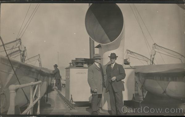 Snapshot of Two Men on Deck of Steamer Boats, Ships