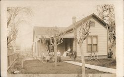Family with Bicycles in Front of House Postcard