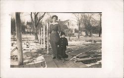 Woman Posing With Child in Toy Wagon Postcard