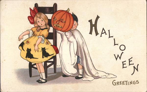 Halloween Greetings. Boy in costume scaring girl.