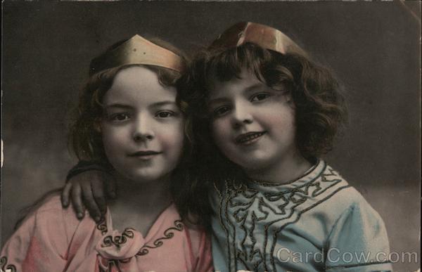 Two Little Girls Wearing Crowns with Their Arms Around Each Other