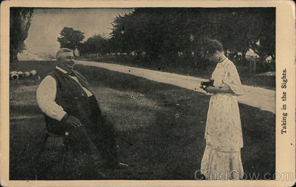 A Woman with a Camera Taking a Picture of a Man Cameras & Photography