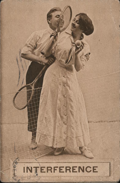 A Man and a Woman Holding Tennis Rackets