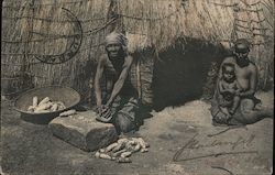 Grinding Corn - Elderly Woman, Woman with Baby, Straw Hut Postcard