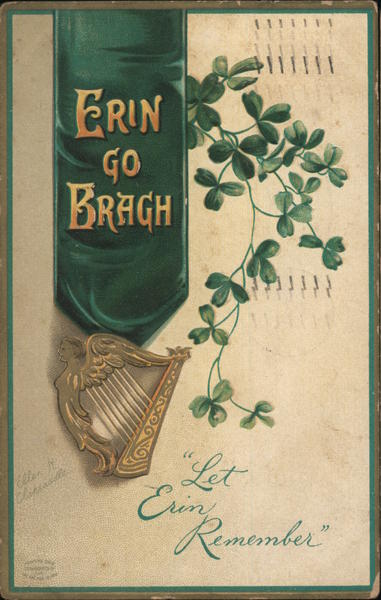 A hard, clovers and a green scarf on a cream colored background.