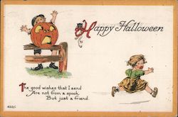 Happy Halloween - boy behind carved pumpkin scares little girl, who runs away Postcard