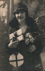 Candid photograph from the 1920s of a young Italian woman bearing gifts and dressed for shopping Postcard