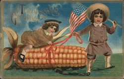 Thanksgiving Greetings - Person holding American flag while another is on a giant ear of corn. Postcard