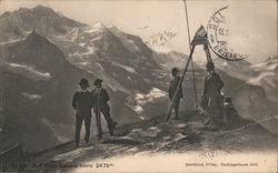 Photograph of four men at the summit of a Swiss mountain Postcard